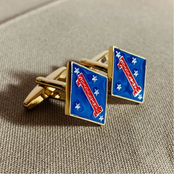 Actual finished 1st Marine Division gold-tone cufflink pair on khaki fabric