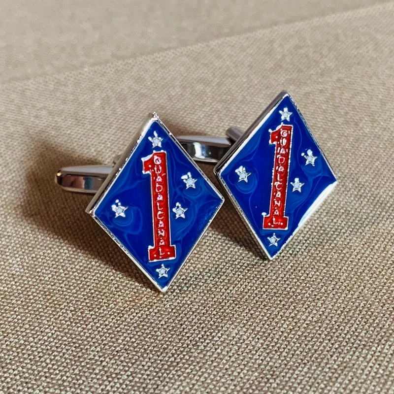 Actual blue and silver-tone 1st Marine Division cufflinks photographed together on khaki fabric
