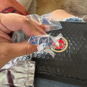 Brittany’s photo of two pairs of cufflinks in clear bags beside Marine Corps packaging.