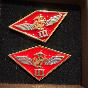 Grayson’s photo of red Marine Aircraft Wing cufflinks in their presentation box.