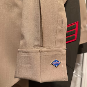 Michael’s photo of a 1st Marine Division cufflink on a khaki uniform shirt cuff.